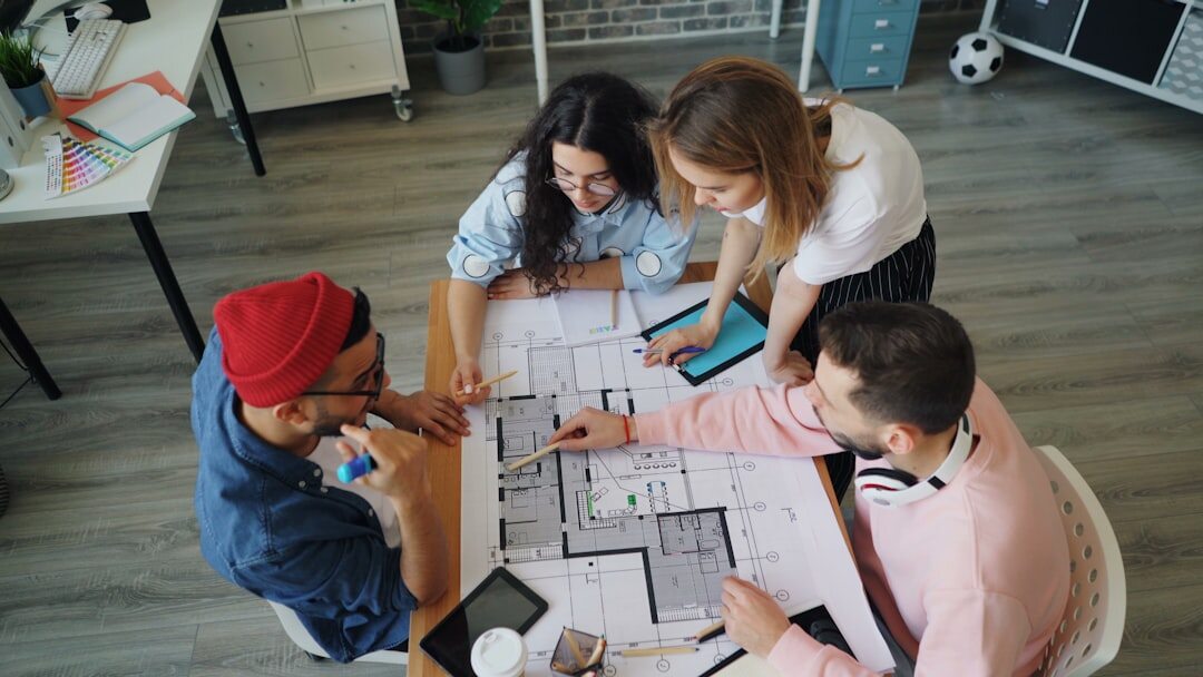 Diverse marketing team reviewing a digital campaign around a table